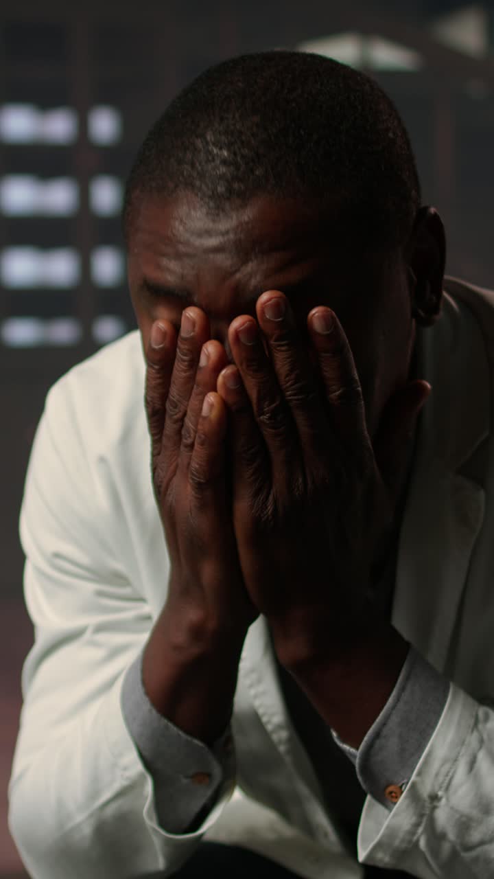 Close-up of a Distressed African American Man Covering His Face