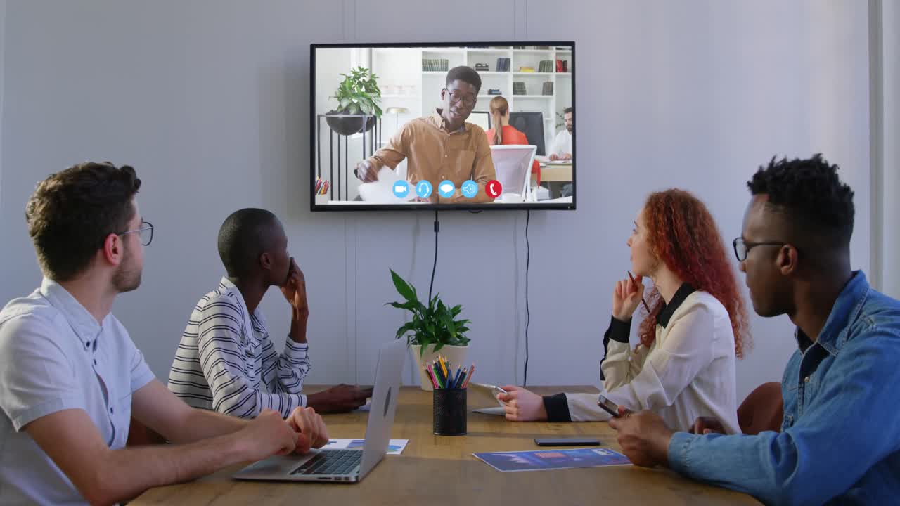 Creative business colleagues in video conference in meeting room in modern office