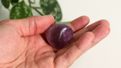 amethyst heart crystal in hand