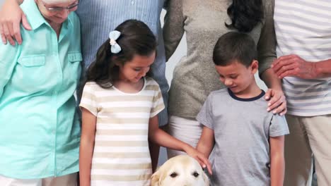 cute family petting a dog in the living room