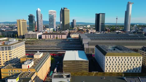 4k aerial drone video of trains entering historic train station in downtown frankfurt, germany