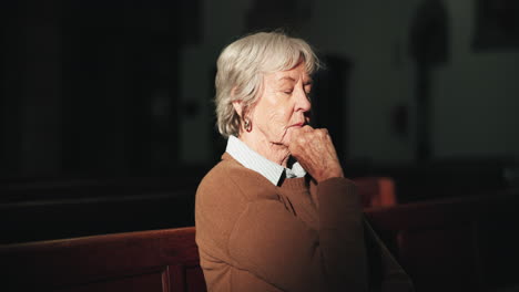 senior woman praying in church