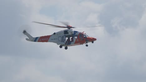 Slowmotion-Tracking-shot-of-the-Dutch-Rescue-coast-guard-helicopter-flying-in-the-air