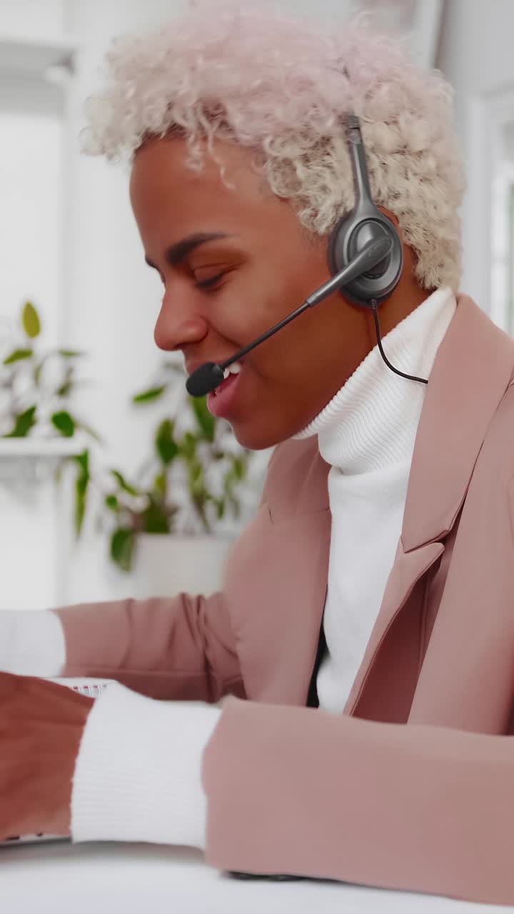 Customer service agent wearing headset using laptop and taking calls