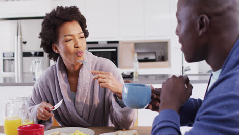 Video-of-happy-african-american-couple-eating-breakfast-together