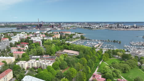 Bird-attacking-a-drone-above-a-nordic-city-on-a-sunny,-summer-day