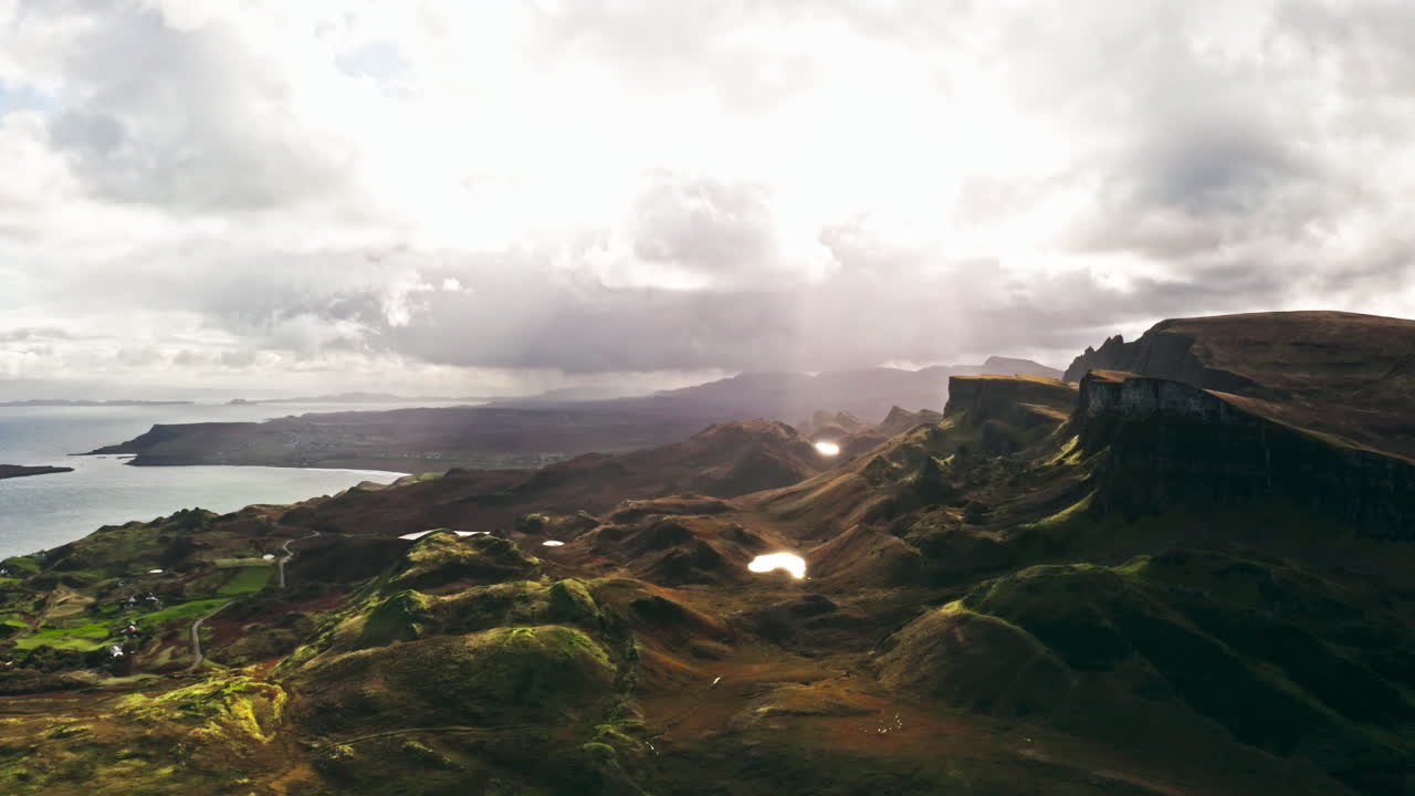 Dramatic Sunny Sky Over The Quiraing - High Cliffs From Massive Landslip On Isle Of Skye, Scotland, UK. wide aerial shot