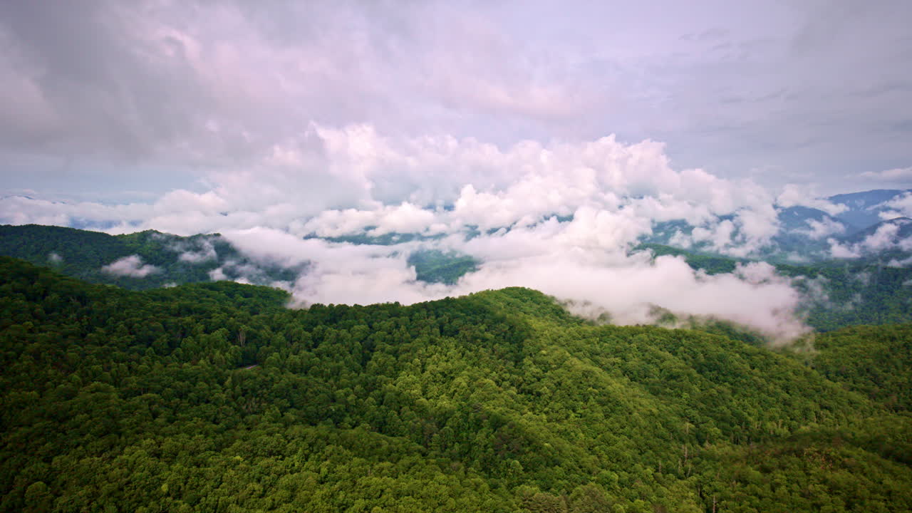 Mountain fog rolls beneath the drone’s cinematic gaze.