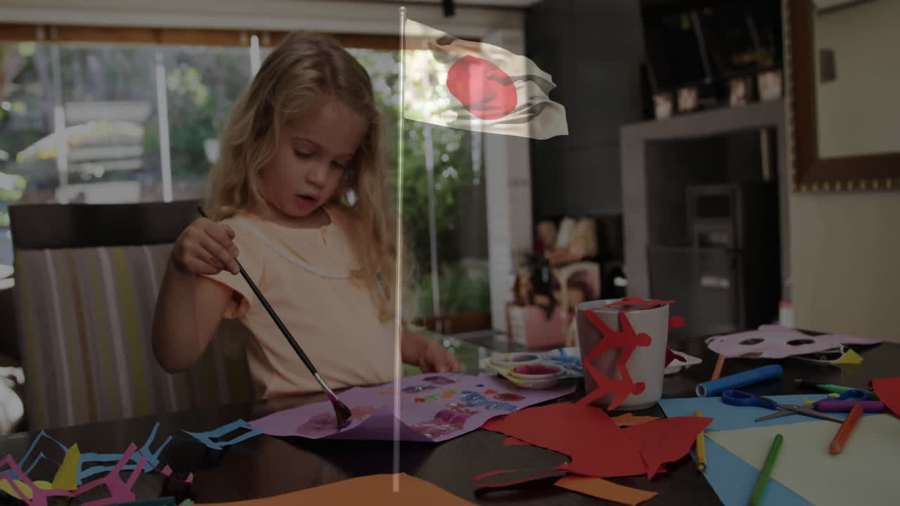 Painting at home, child with Japanese flag overlay creating animation artwork