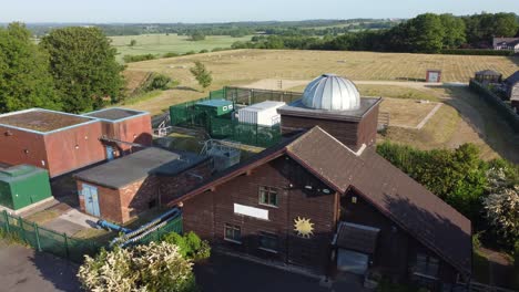 aerial view pex hill leighton observatory silver dome rooftop on hilltop farmland at sunrise, slow reverse reveal left