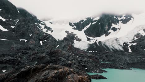 ice field and rocky mountains, glaciar vinciguerra in ushuaia, tierra del fuego province, argentina - drone shot