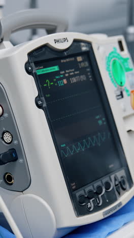 advanced portable equipment working in the hospital ward. apparatus showing the life signs of a patient under surgery. vertical video