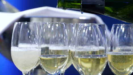 close up view, champagne being poured into champagne glasses