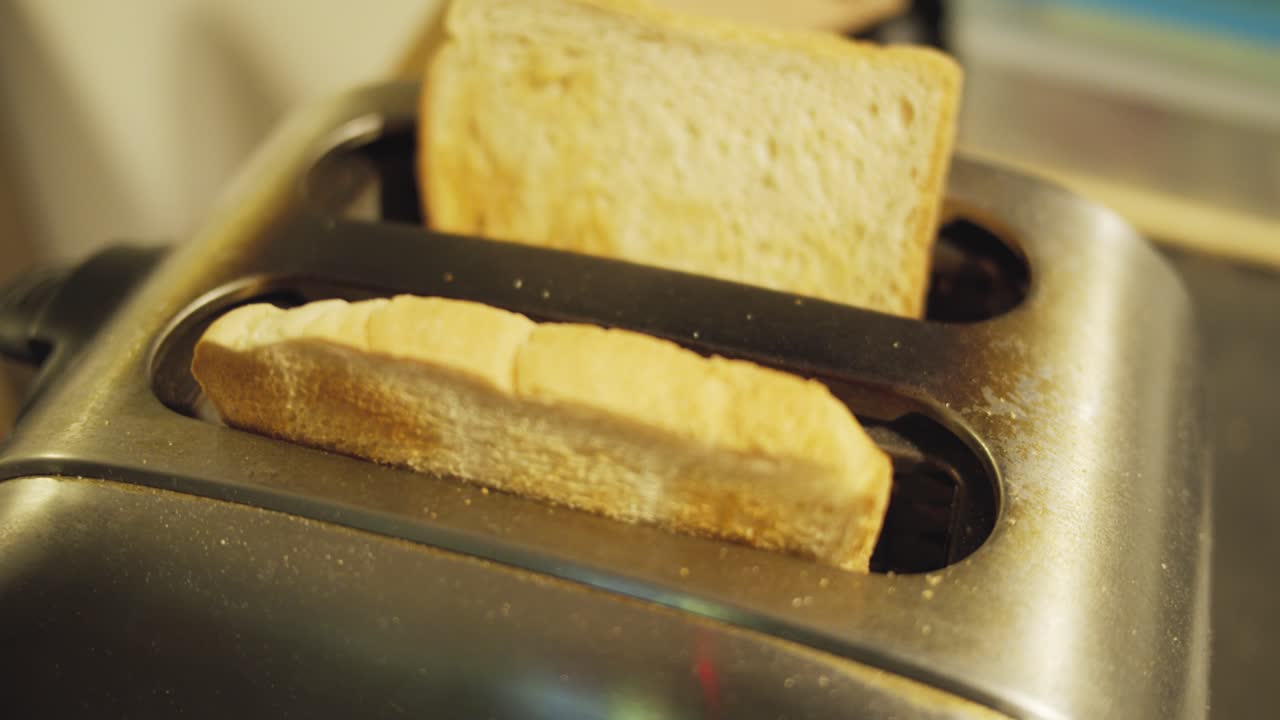 Slow motion shot of toast jumping out of an old toaster