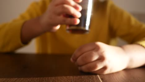 a person holding a glass of soda