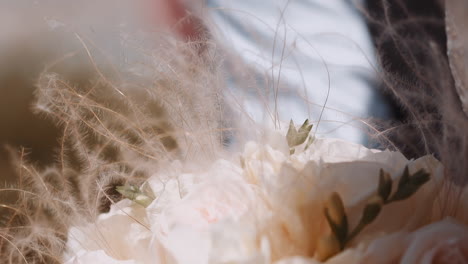 Bride-woman-holds-fresh-bouquet-with-gentle-feather-grass