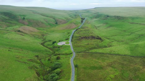 a long road leading up into green hills and countryside