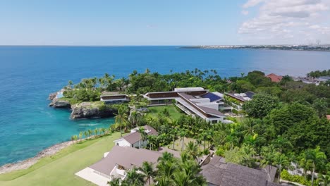aerial view of exclusive oceanfront villa with pool, tropical garden, modern architecture, overlooking turquoise caribbean waters, casa de campo, la romana, dominican republic