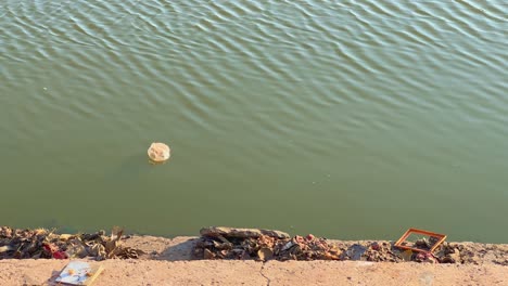 plastic bag floating on the water of lake or pond in india, water pollution is a big problem in india