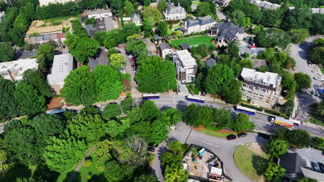 High-angle-view-of-group-of-buses-passing-through-urban-neighborhood