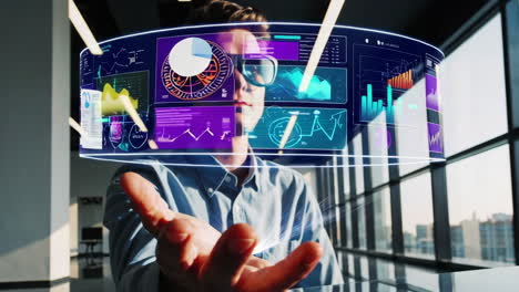 man interacting with a holographic data display