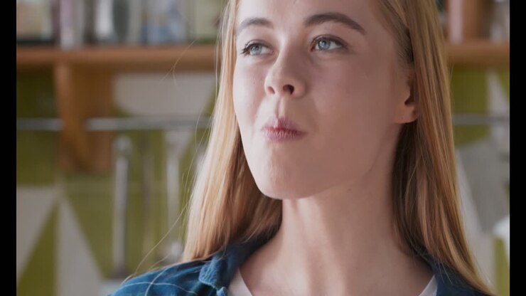 Young Woman Eating a Lemon