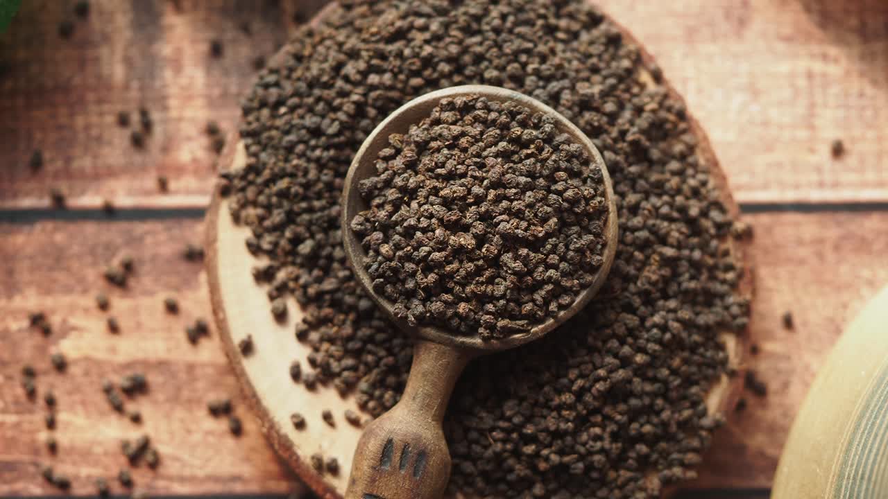 Loose leaf black tea in a wooden spoon