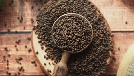 loose leaf black tea in a wooden spoon