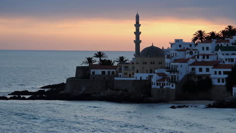 coastal town with mosque at sunrise/sunset