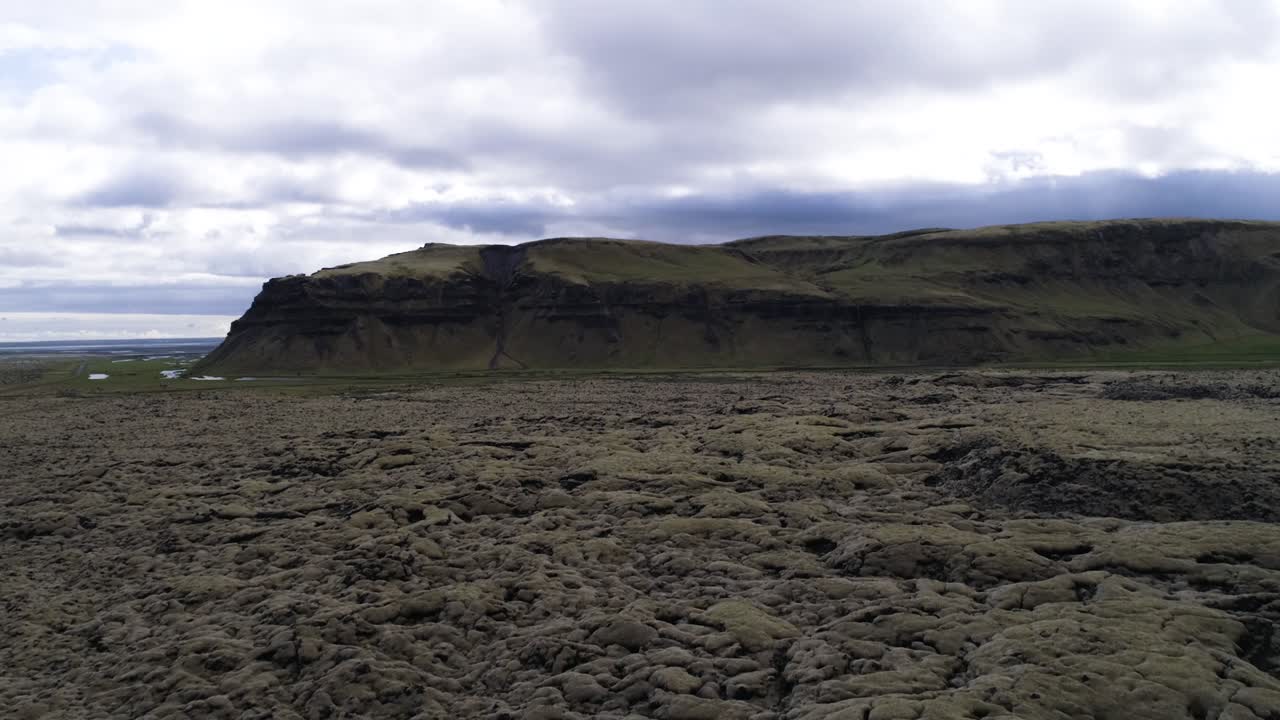 aerial shot of volcanic stone covered with moss in iceland