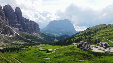 verdant alpine meadows stretch beneath towering dolomite peaks at passo gardena