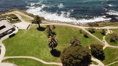 4K-Panning-Aerial-View-of-Point-Vincente-in-Rancho-Palos-Verdes,-Los-Angeles,-California-with-Crystal-Clean-Water-of-the-Pacific-Ocean-on-a-Warm-clear-day-with-Palm-Trees