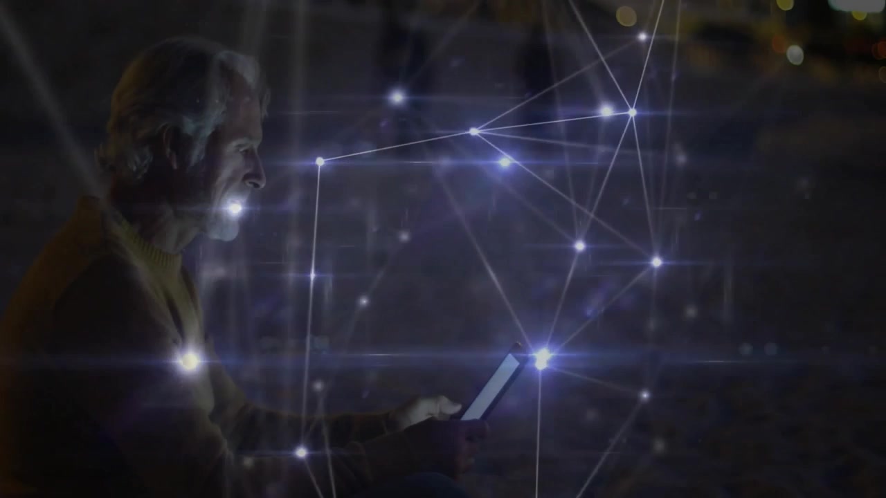 Senior man tapping tablet at waterfront, generating network nodes for tech data mapping