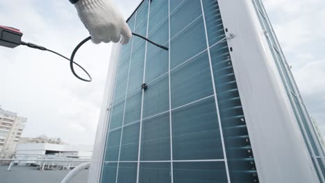 the technician uses a digital camera to check the clogging of the heat exchanger