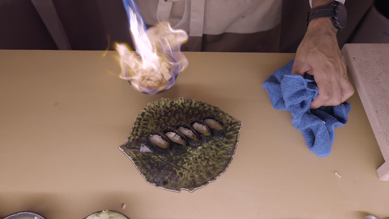 Chef preparing Flamed Sushi