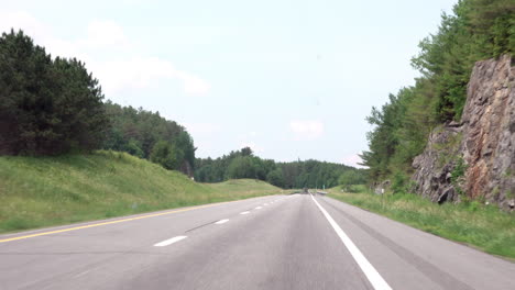 driving on a highway bordered with trees