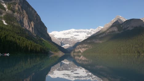 Lake-Louise-waters,-mirror-surrounding-landscape-with-crystalline-clarity