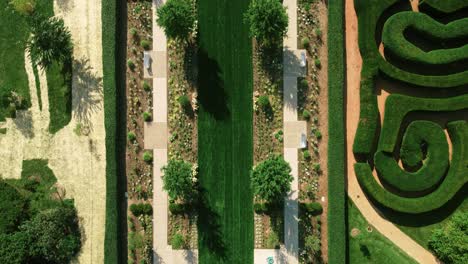 cinematic overhead shot of long green path ending with circular, morton arboretum park, chicago