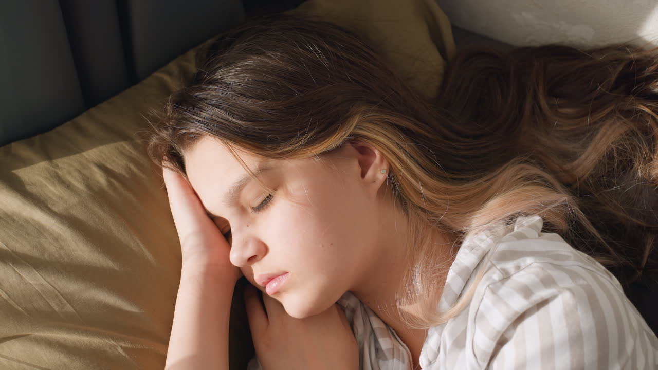 Youth Resting With Calm Serenity, Quiet Youthful Repose Captured In Soft Lighting Environment, Serene Young Individual Relaxing On Pillow With Gentle Breath In Peaceful Room Atmosphere