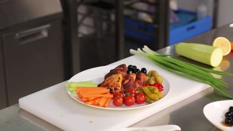 chef preparing a delicious chicken wing appetizer with vegetables