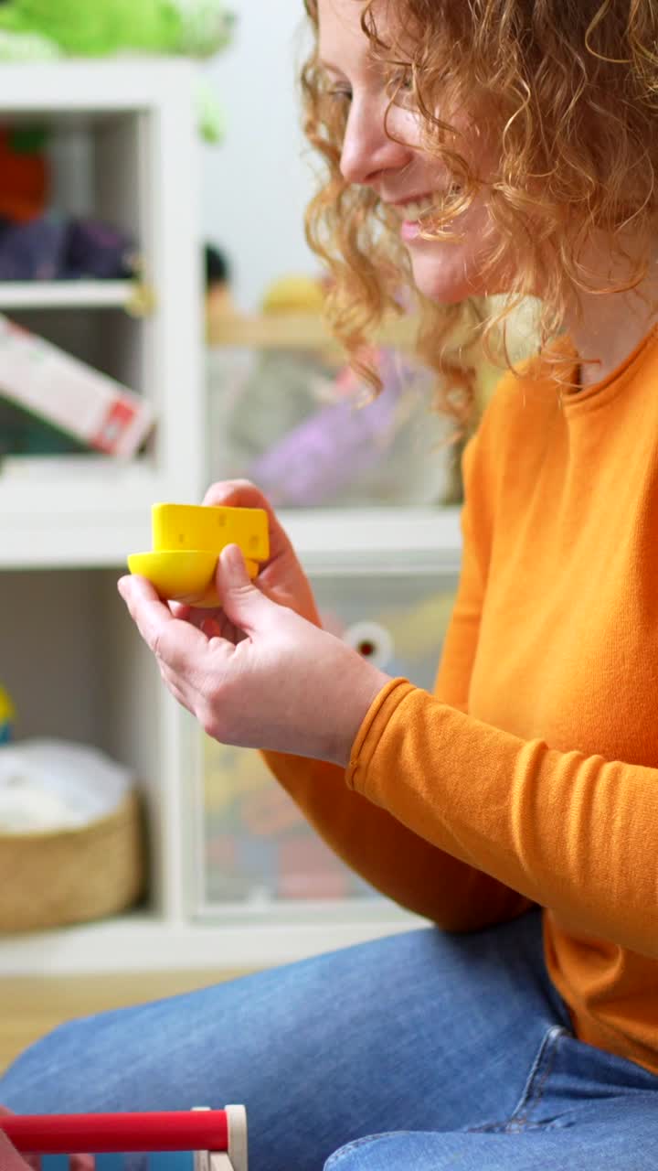A child playing with toys with a woman at home