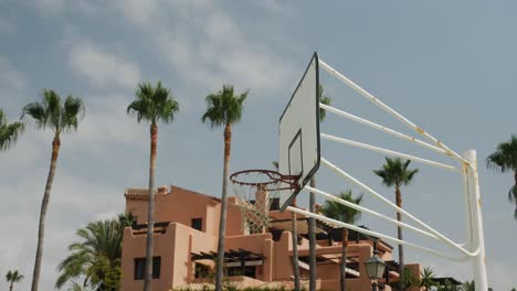 tilted arc shot of a basketball ring on a sunny day in spain