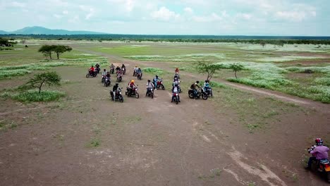 viajeros en pitstop durante un safari en motocicleta en kenia - toma aérea de drones