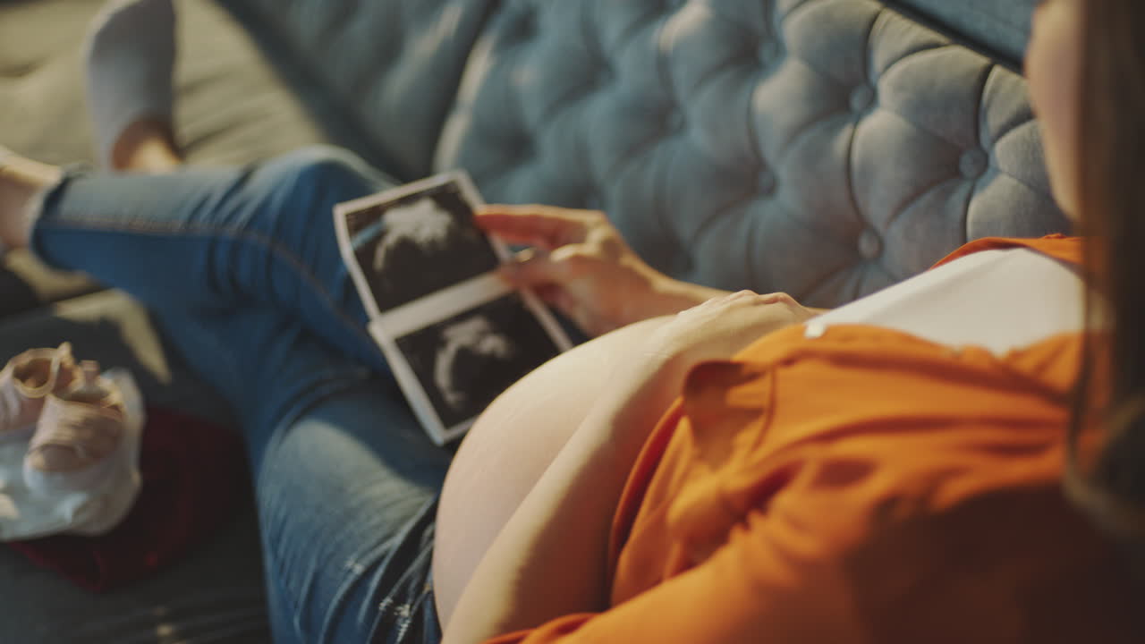Pregnant Woman Looking at Ultrasound Pictures