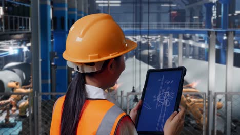 engineer reviewing a technical drawing in a manufacturing facility