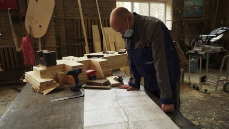 woodworker reviewing plans in workshop