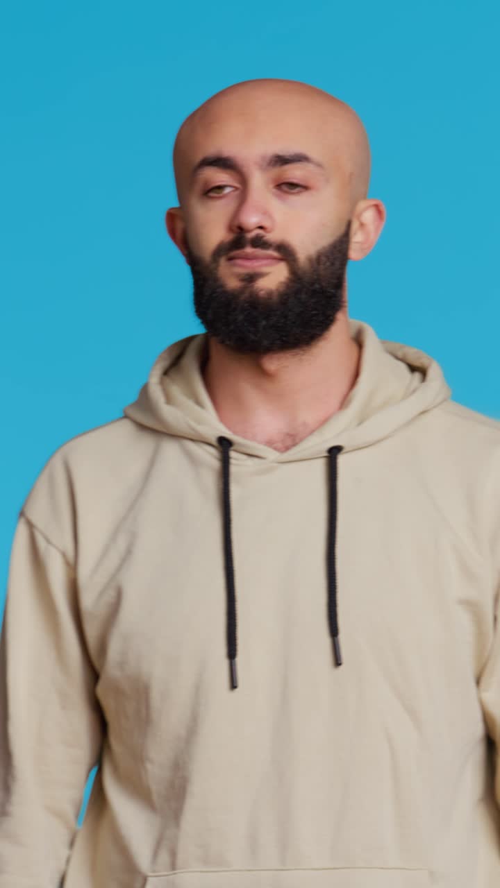 Vertical Video Middle eastern confident person posing on studio camera