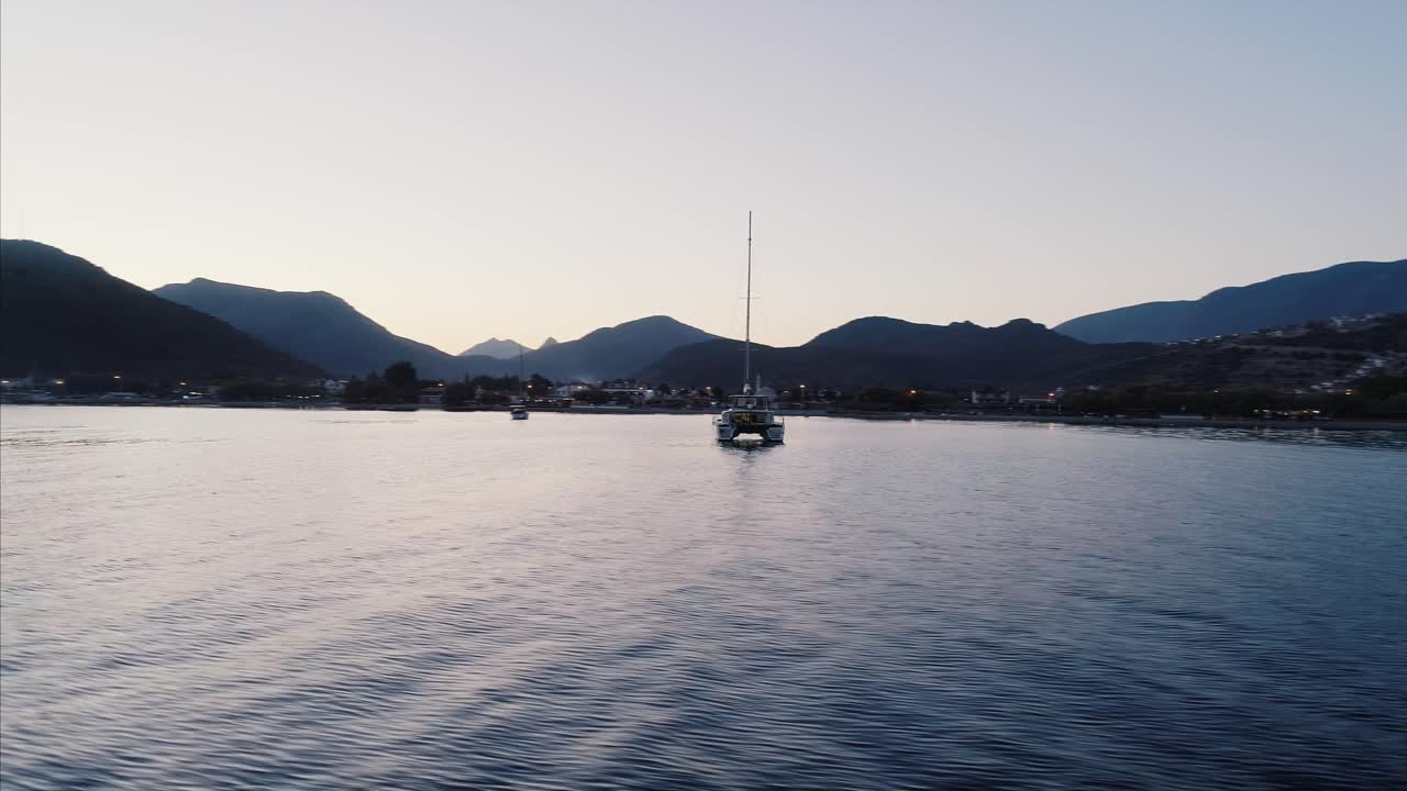 Yacht by the shore at sunset aerial