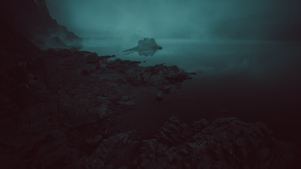 Misty shoreline at twilight with tranquil waters and rocky landscape