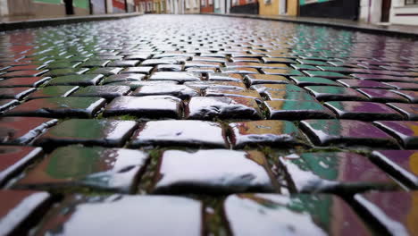 rainy cobblestone street in a colorful european town